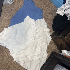 7 assorted newborn onesies